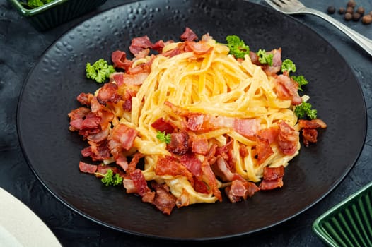 Pasta with fried bacon on a plate, pasta carbonara. Keto diet.