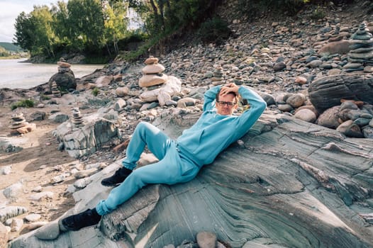 Man at the river Katun at summer day. Trip on Altai Mountains in Altai Republic
