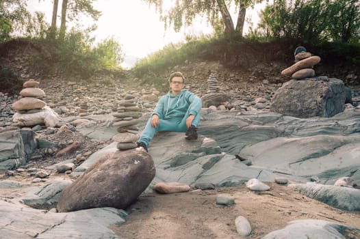 Man at the river Katun at summer day. Trip on Altai Mountains in Altai Republic