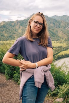 Woman at the river Katun at summer day. Trip on Altai Mountains in Altai Republic