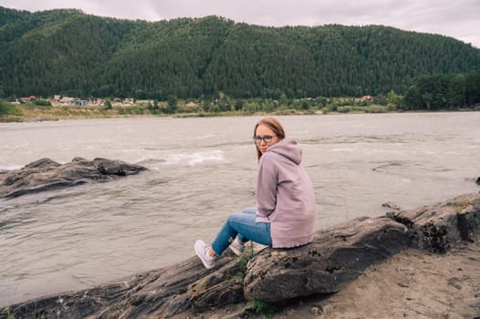 Woman at the river Katun at summer day.