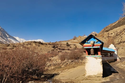 Prayer wheels in a desert like landscape, on the trail between Manang and Yak Kharka, Ledar, Thorung, Thorung Phedi, Annapurna Circuit Trek, Nepal 2022