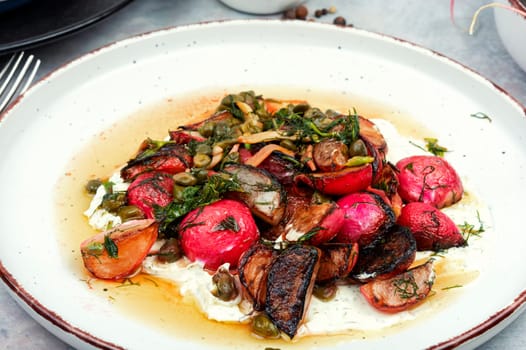 Piccata of fried red radishes, capers and garlic. Vegetarian salad.