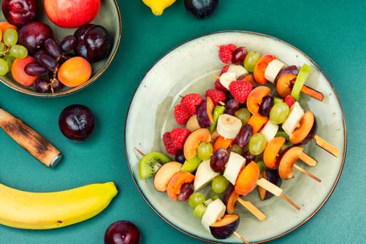 Skewers made from fresh fruits on wooden sticks.