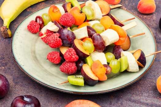 Skewers made from fresh fruits on wooden sticks.