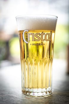 Antwerp, Belgium, July 21st 2024, Illustrative Editorial: Closeup of Cristal Alken glass of beer