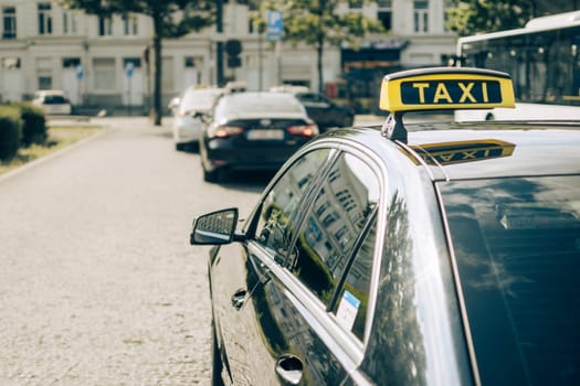Antwerp, Belgium, July 21st 2024: closeup and rear view of taxi in line waiting for passengers to pick up in the streets of Antwerp