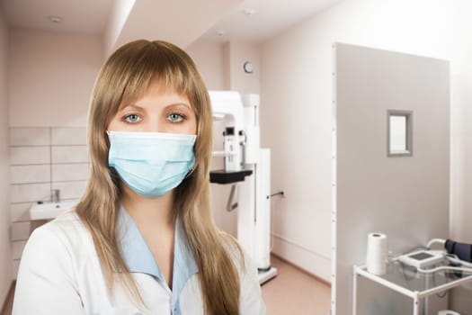 Female doctor mammologist or radiologist working in the room with equipment for breast x-ray