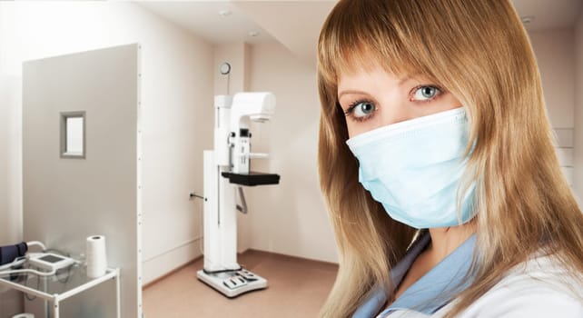 Female doctor mammologist or radiologist working in the room with equipment for breast x-ray