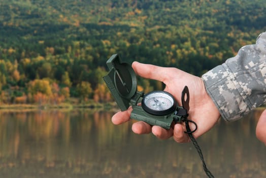 Man with compass in hand n Altai mountains. Travel concept.