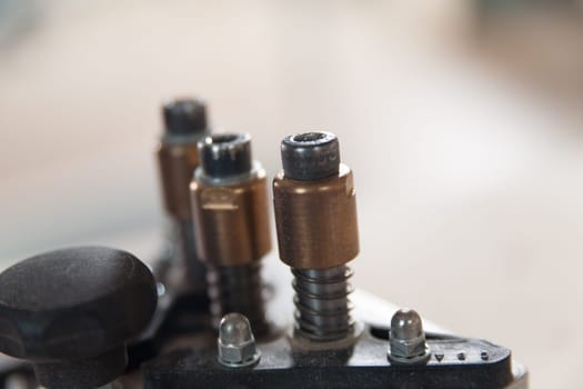 Close up of woodworking machinery parts in a busy workshop, showcasing precision and craftsmanship