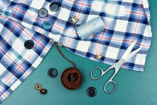 Colored threads and needles for sewing. Different sewing accessories