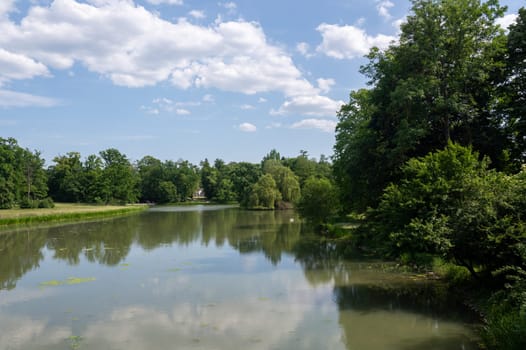 Small lake in a park, in a green landscape with a blue sky