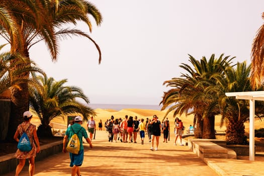 Gran Canaria, Spain, Canary Islands, Playa del Inglés - Jun 17, 2024. Tourist at a viewpoint of Dunes de Maspalomas. Maspalomas Dunes Nature Reserve.