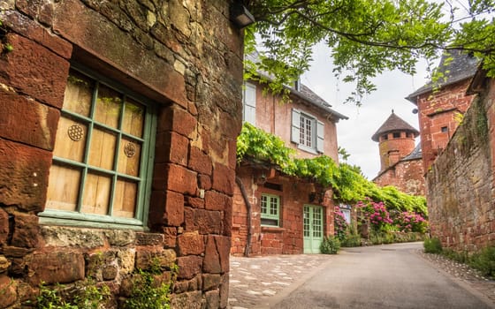 Red houses photographed from the street in Collonges-la-Rouge, one of the most beautiful villages in France, Corrèze