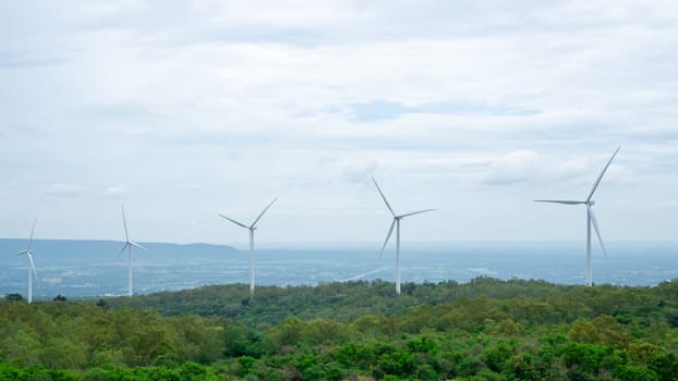 Energy generator nature friendly, Wind energy turbines in the midst of nature, Gorge and trees sky background, Spring field, Concept of sustainable energy development.