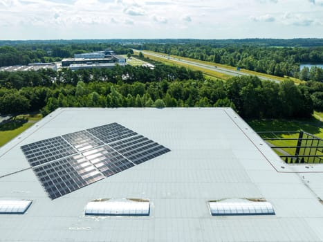 aerial shot of a warehouse roof with solar panels on it