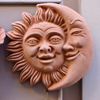 Massa Italy - Sept 11, 2022: Lovely sun and moon couple on the window of a shop with typical Italian ceramics in Massa Maritima. Tuscany, Italy