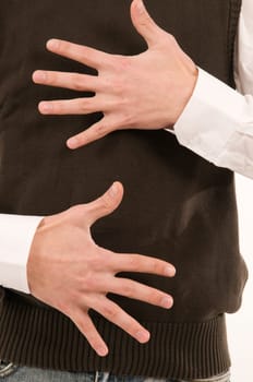 Two male hands held in front of the stomach symbolize the number 10 with the fingers.