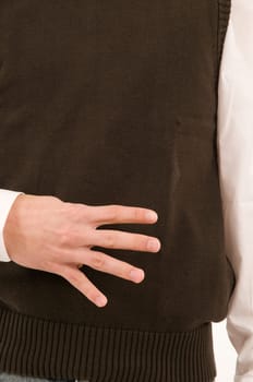 A male hand held in front of the stomach symbolizes the number 4 with the fingers.