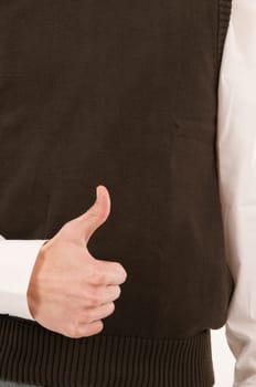A male hand held in front of the stomach symbolizes the number 1 with the fingers.