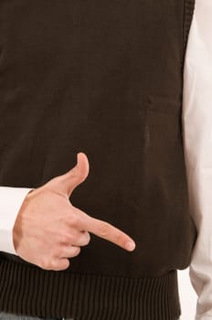 A male hand held in front of the stomach symbolizes the number 2 with the fingers.