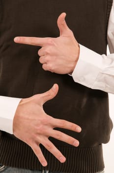Two male hands held in front of the stomach symbolize the number 7 with the fingers.