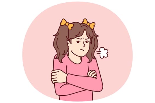 Angry little girl stands with arms crossed feeling hurt after being punished by kindergarten staff. Pre-teenage girl feels resentful after argument with parents or elementary school teachers
