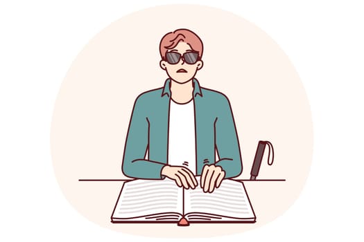 Blind man reads braille book by touching fingers to textbook with three-dimensional letters to gain knowledge. Blind guy with braille book is self-educating and studying new literature