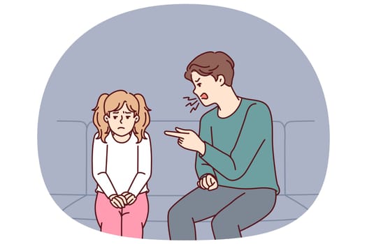 Father scolding teenage daughter because of bad behavior at school sitting on couch in apartment. Dad punishes little girl, screams and points finger at daughter after teacher call or bad grades