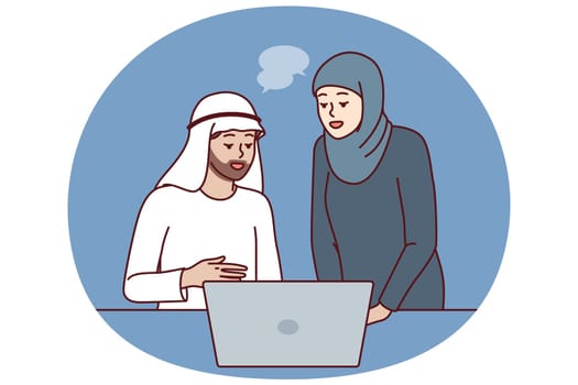 Office workers in Arabic clothing discussing business presentation from laptop. Arabic man and woman work together in corporation in dubai or emirates and conduct business negotiations via internet.