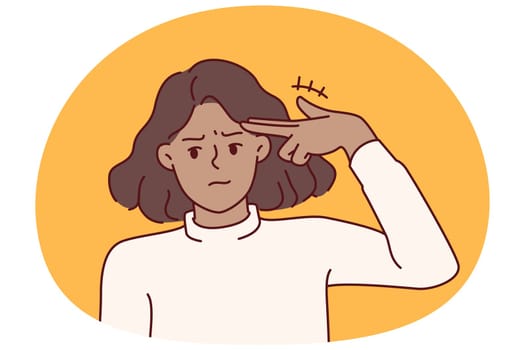 Woman with smirk makes pistol gesture, putting fingers to temple for metaphor for suicide associated with problems in personal life. Young girl wishes to commit suicide after relationship problems