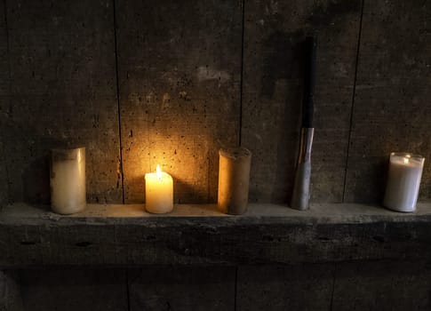 Detail of lit wax candles, traditional lighting