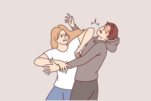 Woman demonstrates self-defense technique by striking man in face pretending to be maniac or robber. Self-defense lessons for girls who want to have sense of security when meeting attacker