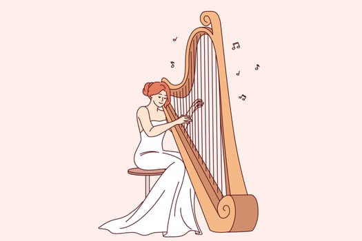 Woman plays large harp, performing at symphony concert or classical music festival. Harp with strings near female musician organizing acoustic music show for connoisseurs of opera performances