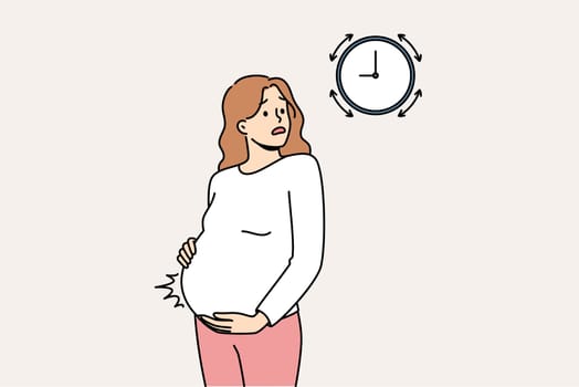 Pregnant woman measures contractions and looks at watch, waiting for ambulance to arrive from maternity hospital. Girl tracks intervals between contractions while waiting for labor to begin.
