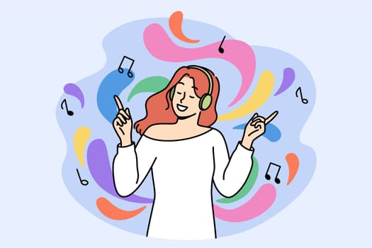 Happy woman music lover listens to music on headphones and energetically waves hands enjoying melody she likes. Teen girl uses wireless technologies and ability to dance to tracks of favorite singers