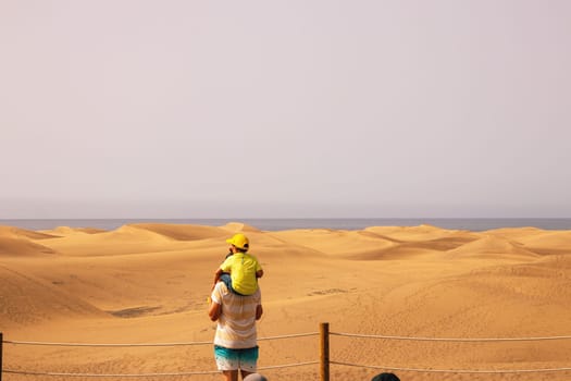 Gran Canaria, Spain, Canary Islands, Playa del Inglés - JUL 17, 2024. Tourist at a viewpoint of Dunes de Maspalomas. Maspalomas Dunes Nature Reserve.