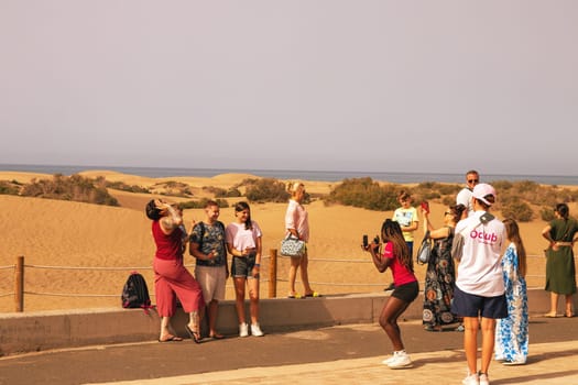 Gran Canaria, Spain, Canary Islands, Playa del Inglés - JUL 17, 2024. Tourist at a viewpoint of Dunes de Maspalomas. Maspalomas Dunes Nature Reserve.