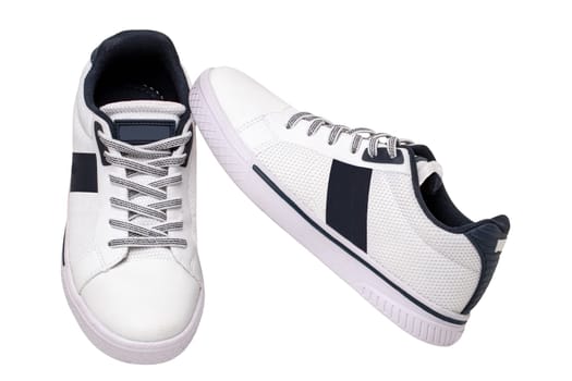 White sneakers isolated. Close-up of a pair white elegant stylish leather sport shoes isolated on a white background. Clipping path. Kids shoe fashion. Modern design footwear for workout. Macro.