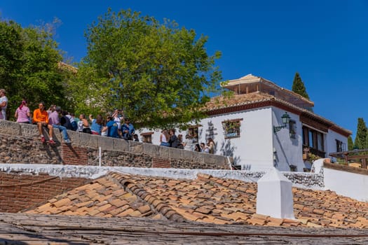 Granada, Spain: April 15, 2024: People at the Albaicin Moorish medieval quarter, traditional arabic architecture of Andalusia. Granada, Spain