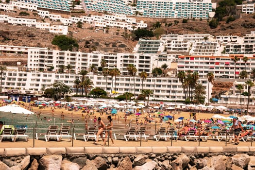 Gran Canaria, Spain, Canary Islands, Puerto Rico - Jul 17, 2024. View of hotels and the Amadores beach with a lot of tourists in Puerto Rico.
