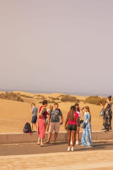 Gran Canaria, Spain, Canary Islands, Playa del Inglés - JUL 17, 2024. Tourist at a viewpoint of Dunes de Maspalomas. Maspalomas Dunes Nature Reserve.