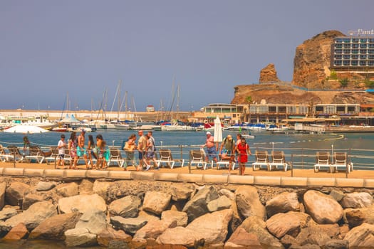 Gran Canaria, Spain, Canary Islands, Puerto Rico - Jul 17, 2024. Tourists in the harbour of Puerto Rico.
