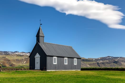 Budir black wooden church green grass field in iceland