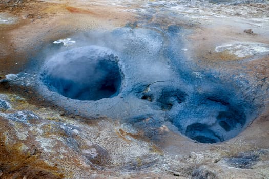 Geothermal Hverir area releasing steam from colorful hot springs