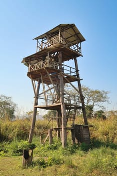 Wooden observation tower, viewing tower, lookout tower, observation deck, observation platform, viewing platform in the grassland, savanna of the Chitwan National Park, Nepal 2022