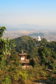 View onto the World Peace Pagoda in front ot the town of Pokhara, on the way up to the shiva statue at the Pumdikot Religious Area, Nepal 2022
