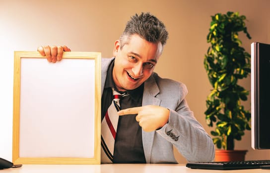 Sneaky businessman in an office, pointing at a whiteboard with a sly smile, hinting at shady sales tactics. Deception, fraud, unethical behavior