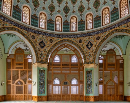 Interior of Taza Pir Mosque in Baku, Azerbaijan, admire its ornate dome and intricate architecture blending traditional Islamic motifs with modern elements
